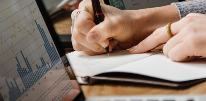 close up of person writing on notebook