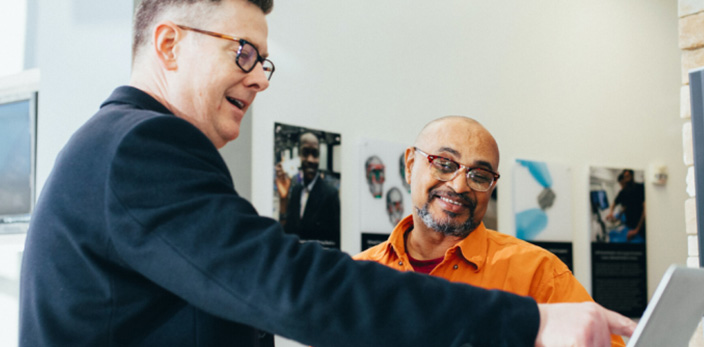 man assisting a visually impaired person