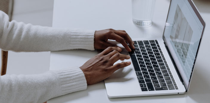 hands typing on laptop