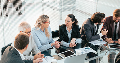 multigenerational group of professionals in an office meeting room