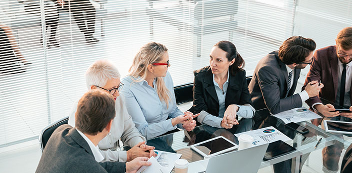 multigenerational group of professionals in an office meeting room