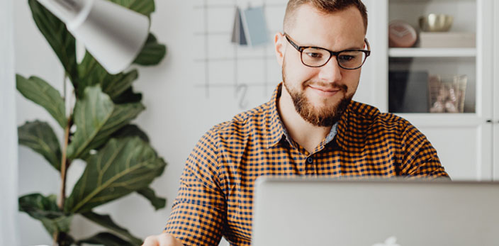 man happily working on his laptop