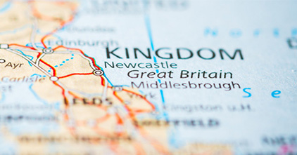 Close up photo of a map pointing to Great Britain