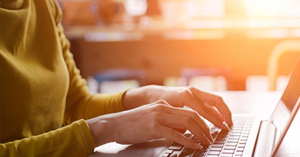 close up of person working on laptop in the afternoon