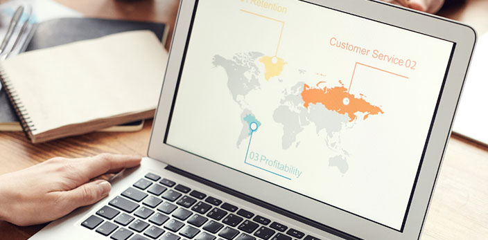 world map with highlighted regions shown on laptop