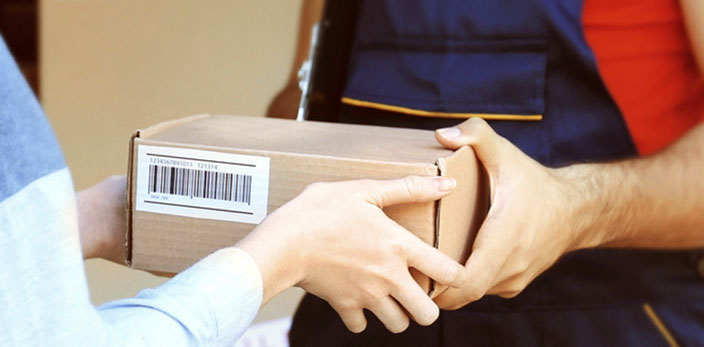 delivery man giving ordered package to recipient