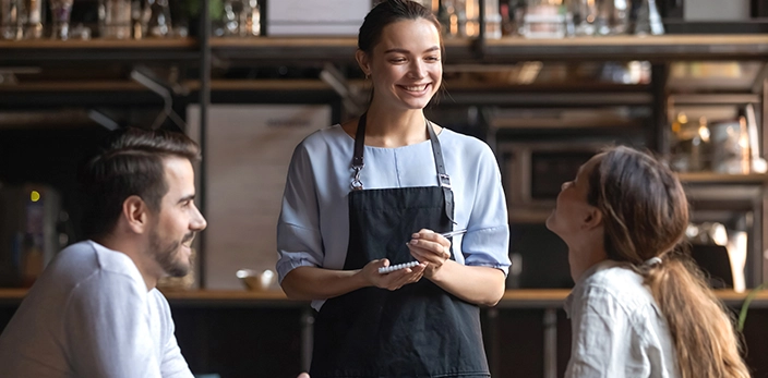 Customer service employee taking orders at a cafe