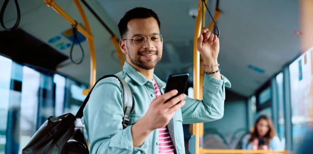 College student learning on phone during commute