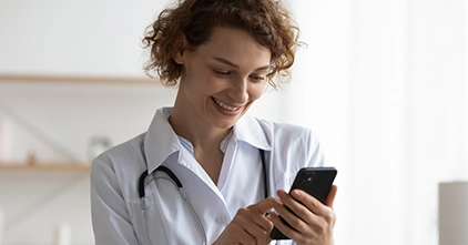 Medical professional using mobile phone to learn a language