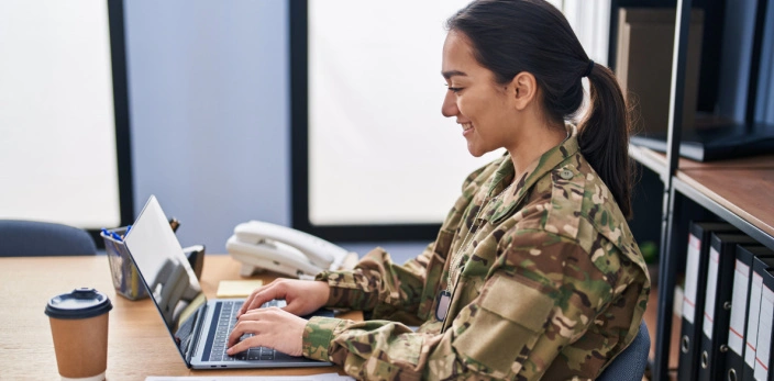female military personnel using laptop