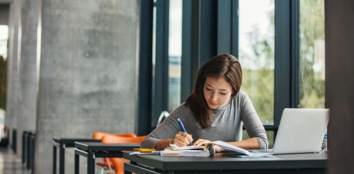 Student learning alone in a library