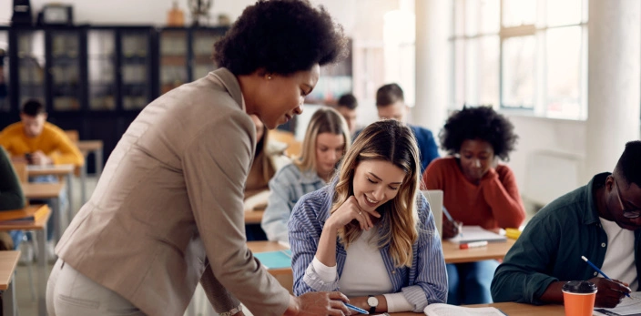 Teacher helping student answering course work