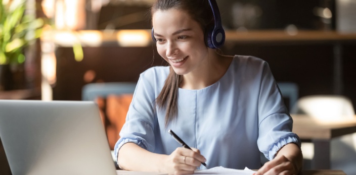 Female-student-with-headphones-and-a-laptop