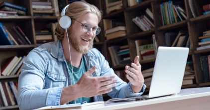 Male-student-with-headphones-and-a-laptop
